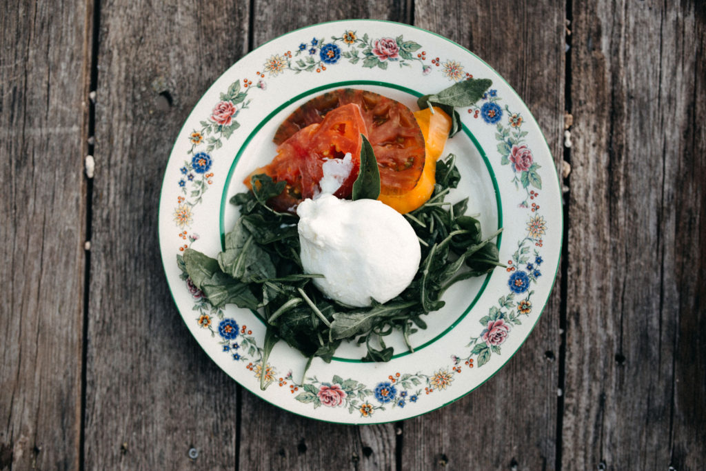 vegetarian dish with leafy greens, tomatoes, and cream