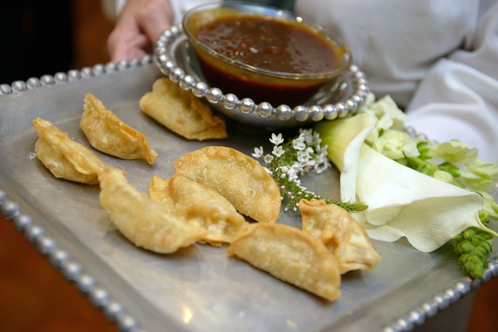 empanadas on silver tray with dipping sauce