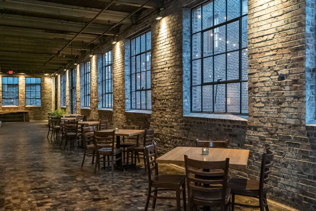 open dining concept with bring industrial style windows
