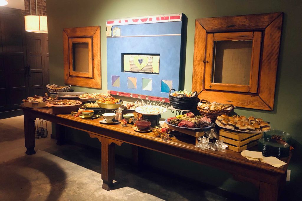 food table in front of blue artwork and wooden frames