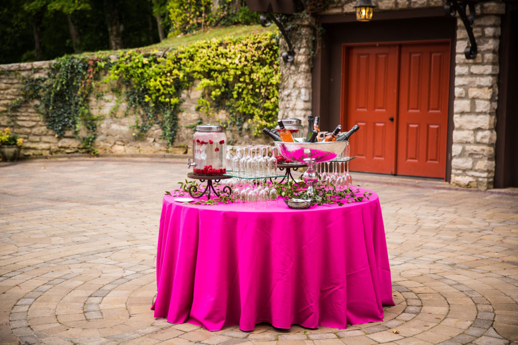 wine and lemonade table on bright pink table cloth
